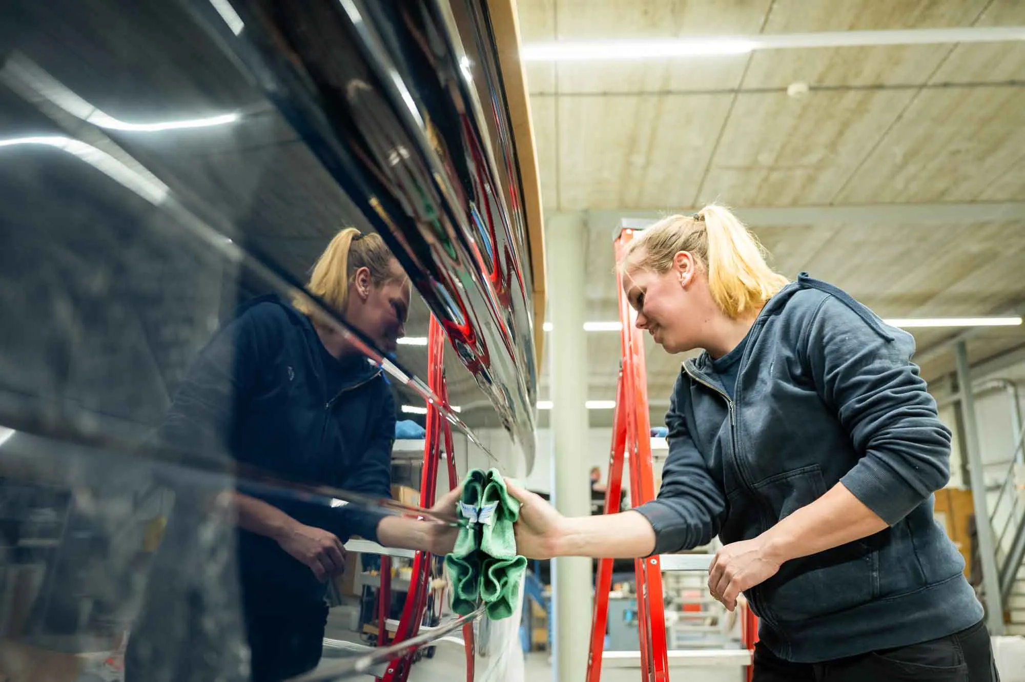 employee puts the finishing touches to the boat