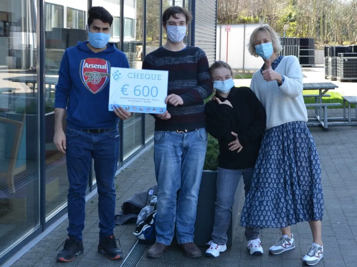 people with face masks and big check