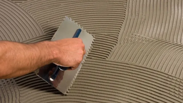 man applying tile adhesive