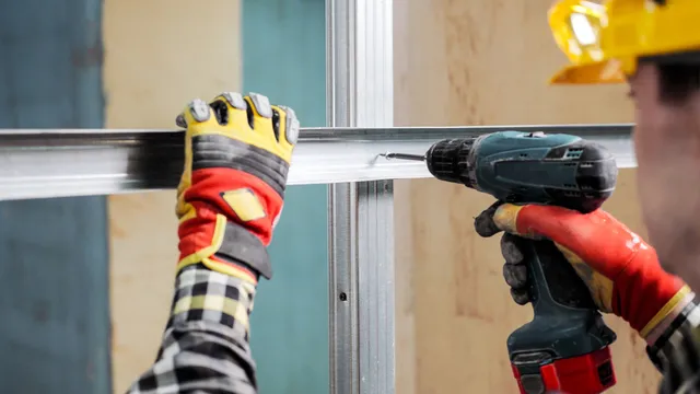 man drills in metal stud