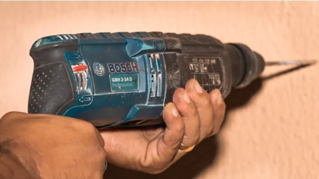 man works with Bosch drill