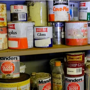 cans of paint on a shelf