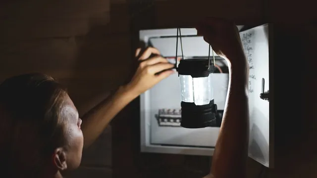 woman checks fuses during a power cut
