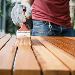 man stain wooden garden table