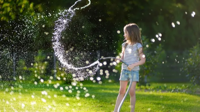 girl sprays lawn