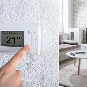 close-persons-hand-adjusting-digital-thermostat